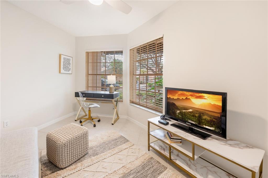 2835 Mizzen Way Naples, FL 34109 - Photo 14 of 46 a living room with furniture and a flat screen tv