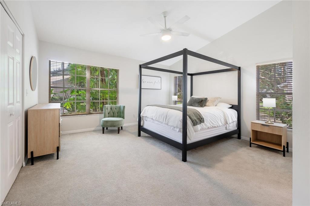 2835 Mizzen Way Naples, FL 34109 - Photo 15 of 46 a bedroom with a bed and a chandelier