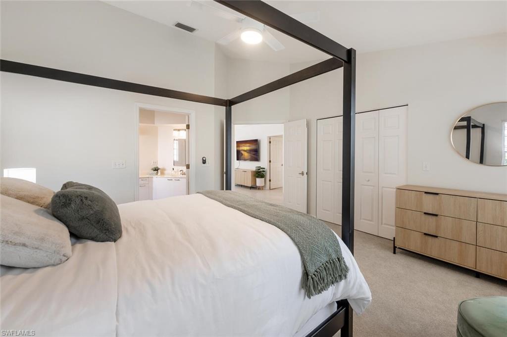 2835 Mizzen Way Naples, FL 34109 - Photo 16 of 46 a bedroom with a bed and a cabinets