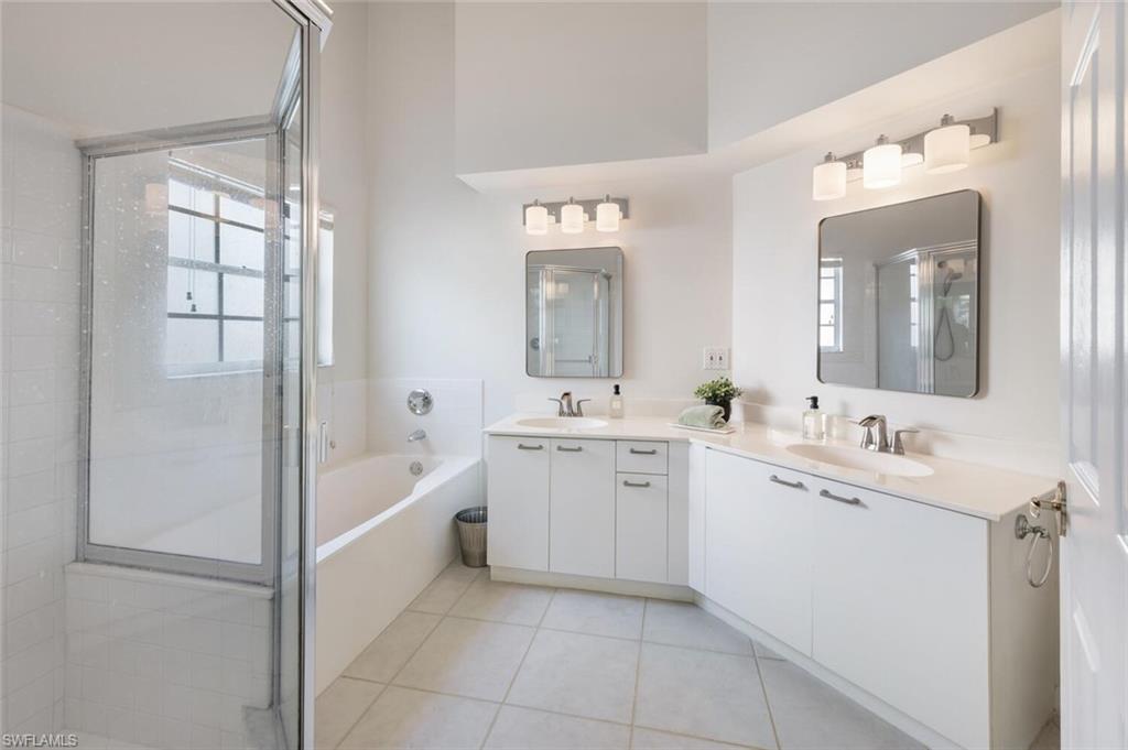2835 Mizzen Way Naples, FL 34109 - Photo 17 of 46 a spacious bathroom with a double vanity sink mirror and bathtub