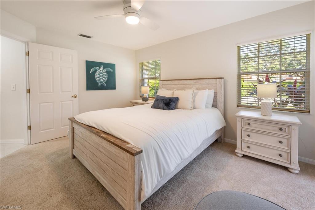 2835 Mizzen Way Naples, FL 34109 - Photo 19 of 46 a bedroom with a bed and a dresser