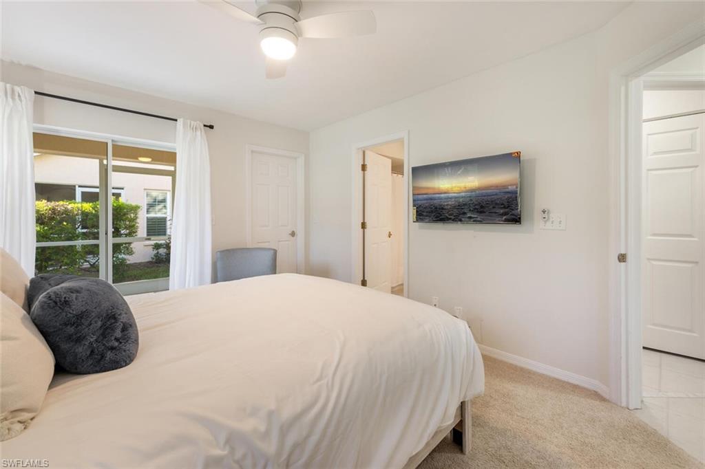 2835 Mizzen Way Naples, FL 34109 - Photo 20 of 46 a large bed sitting in a bedroom next to a window