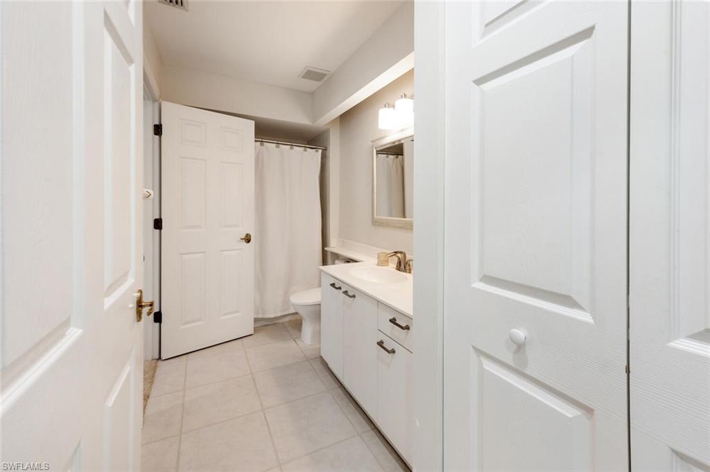 2835 Mizzen Way Naples, FL 34109 - Photo 23 of 46 a bathroom with a sink and a mirror