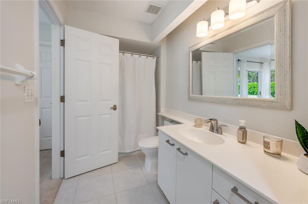 2835 Mizzen Way Naples, FL 34109 - Photo 24 of 46 a bathroom with a sink and a mirror