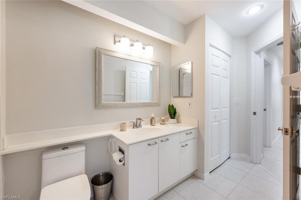 2835 Mizzen Way Naples, FL 34109 - Photo 26 of 46 a bathroom with a toilet sink and mirror