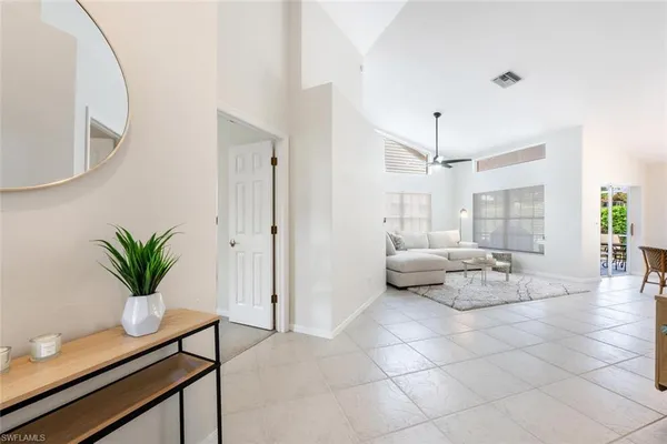 a living room with furniture and a potted plant