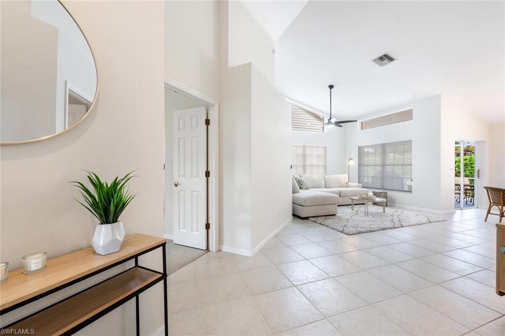 2835 Mizzen Way Naples, FL 34109 - Photo 3 of 46 a living room with furniture and a potted plant