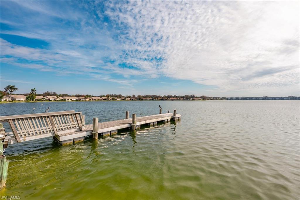 2835 Mizzen Way Naples, FL 34109 - Photo 45 of 46 a view of a lake with table and chairs