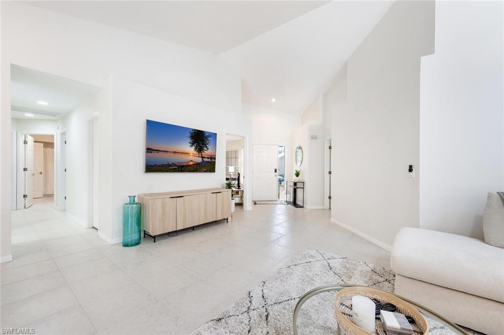 2835 Mizzen Way Naples, FL 34109 - Photo 5 of 46 a living room with furniture and a flat screen tv