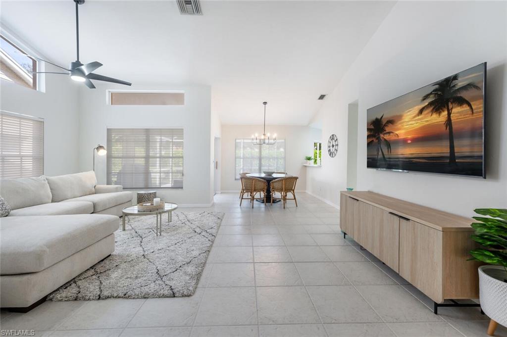 2835 Mizzen Way Naples, FL 34109 - Photo 6 of 46 a living room with furniture and a flat screen tv