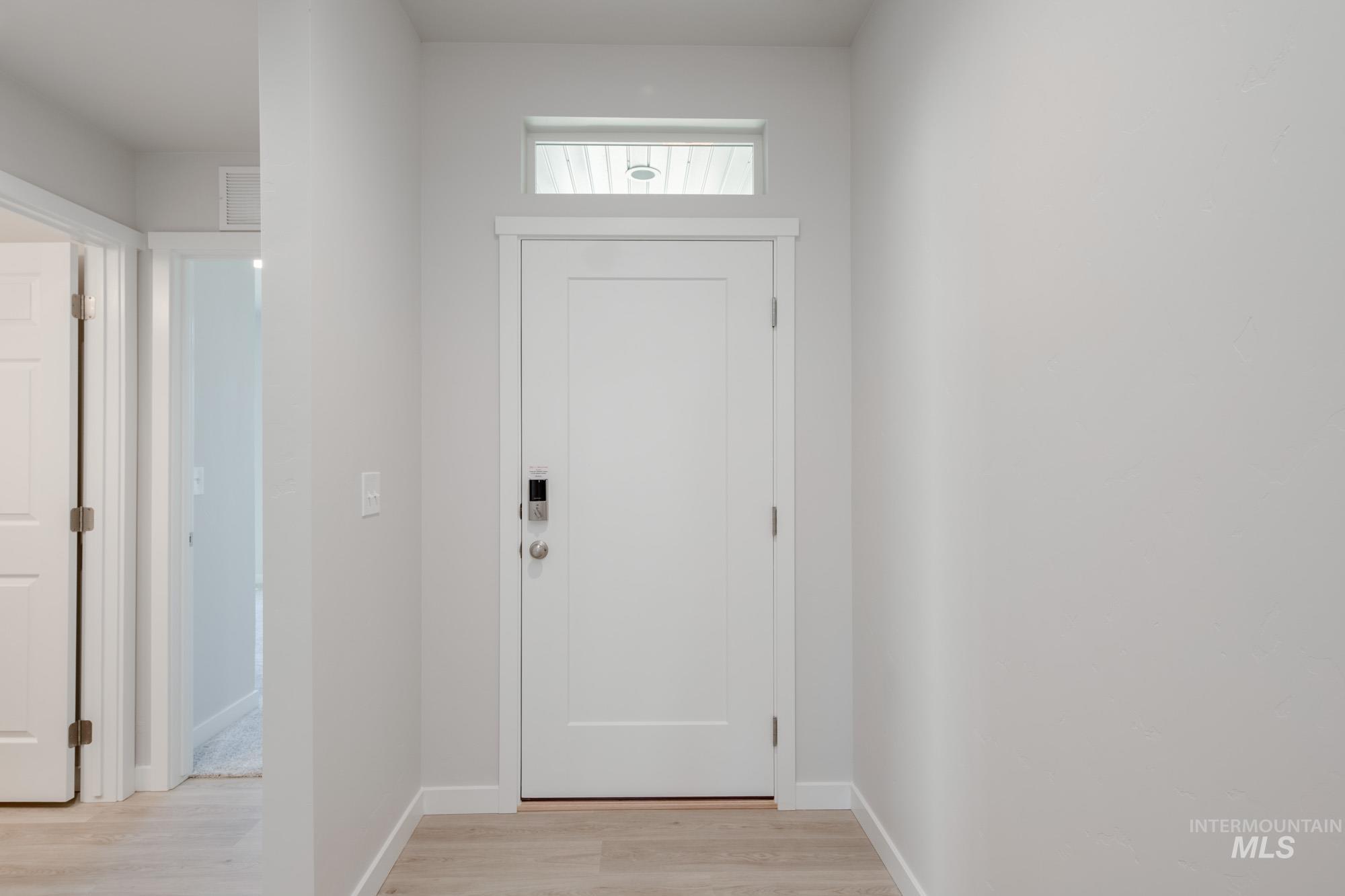 7472 South Menzingers Avenue Meridian, ID 83642 - Photo 2 of 22 Entryway with light wood-style floors and baseboards