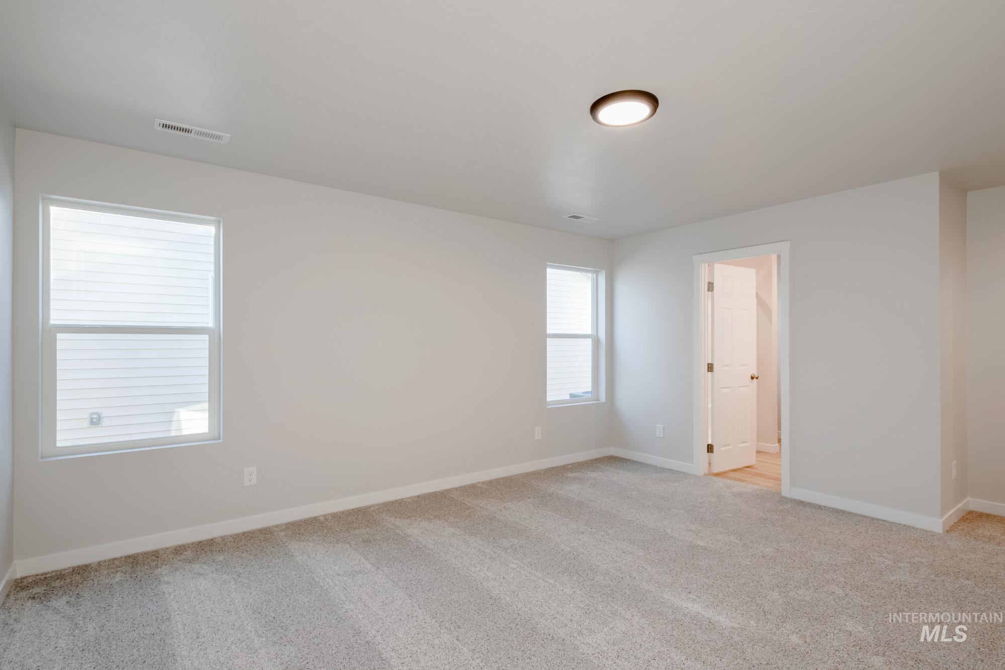 7472 South Menzingers Avenue Meridian, ID 83642 - Photo 21 of 22 Spare room featuring light colored carpet and baseboards