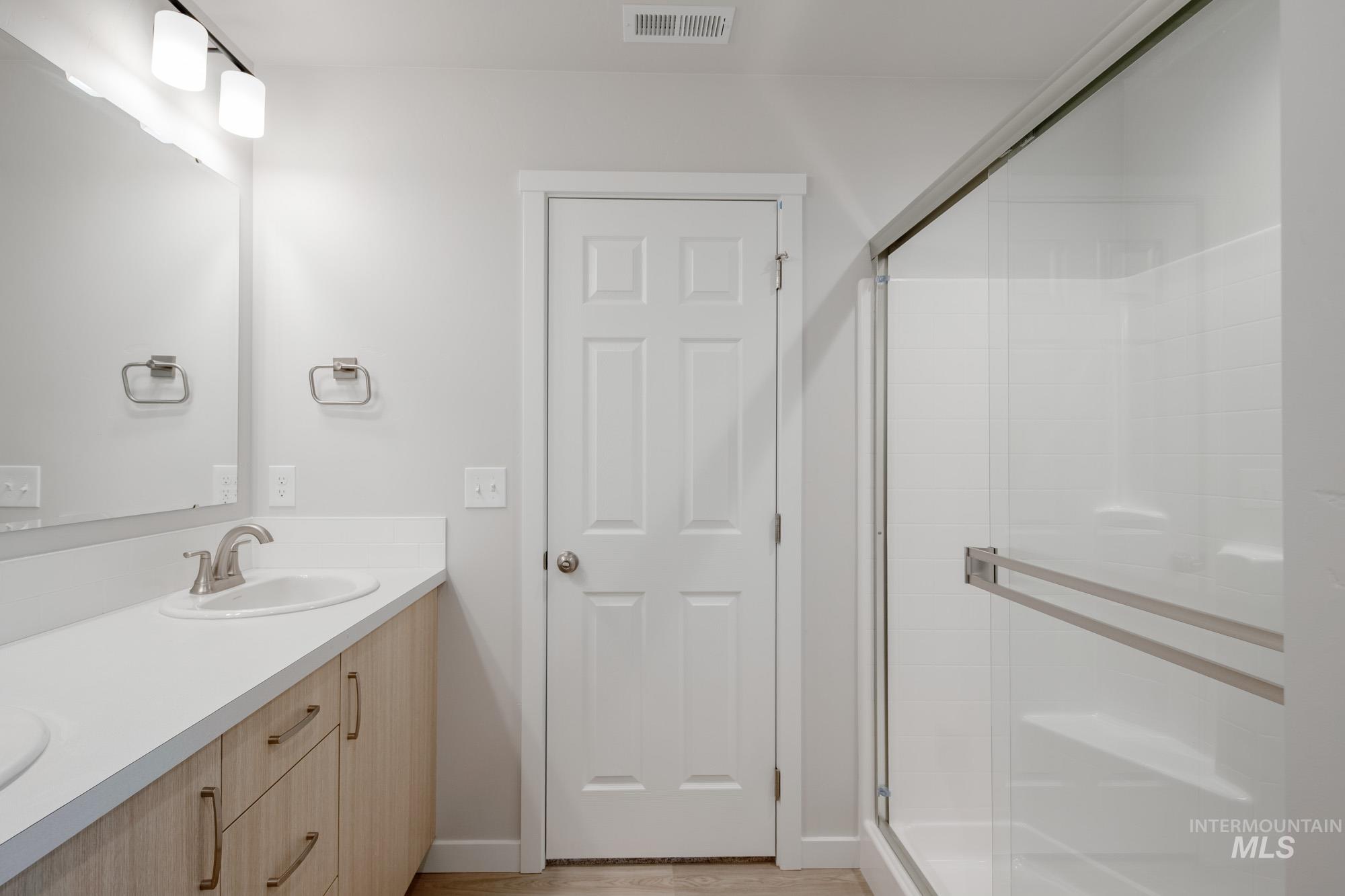 7472 South Menzingers Avenue Meridian, ID 83642 - Photo 22 of 22 Full bathroom with double vanity and a shower stall