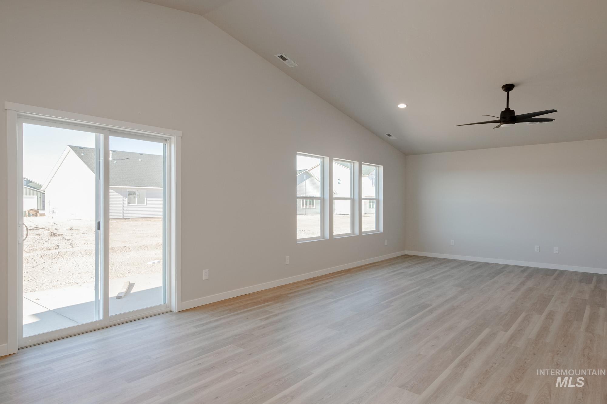 7472 South Menzingers Avenue Meridian, ID 83642 - Photo 8 of 22 Spare room featuring lofted ceiling, light wood-style floors, a ceiling fan, and recessed lighting