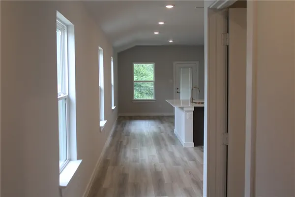 a view of hallway with wooden floor