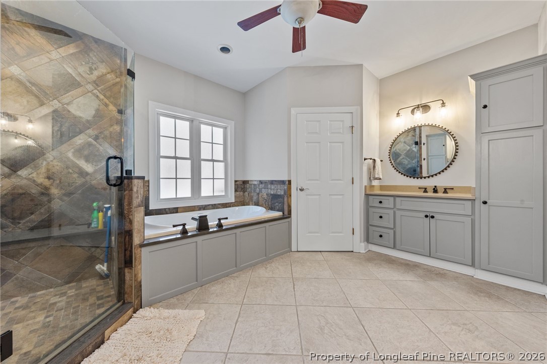 30180 East Lake Road Wagram, NC 28396 - Photo 24 of 42 a large bathroom with a large tub shower and sink