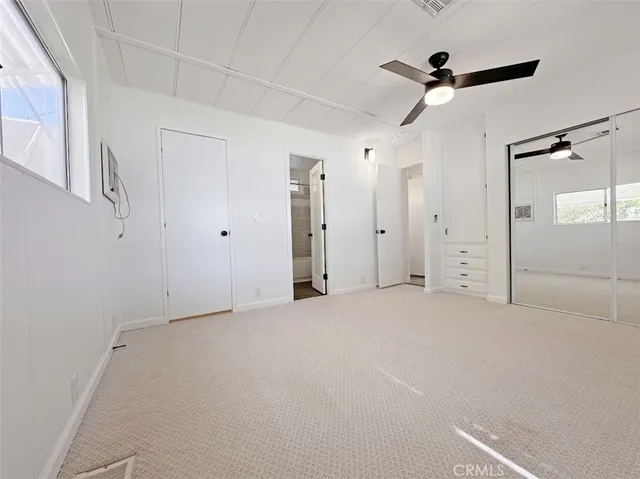 a view of empty room with ceiling fan