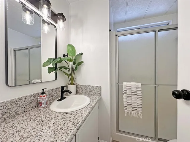 a bathroom with a sink a vanity and a mirror