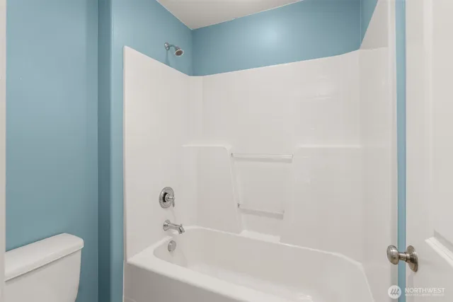 a bathroom with a bathtub and a toilet