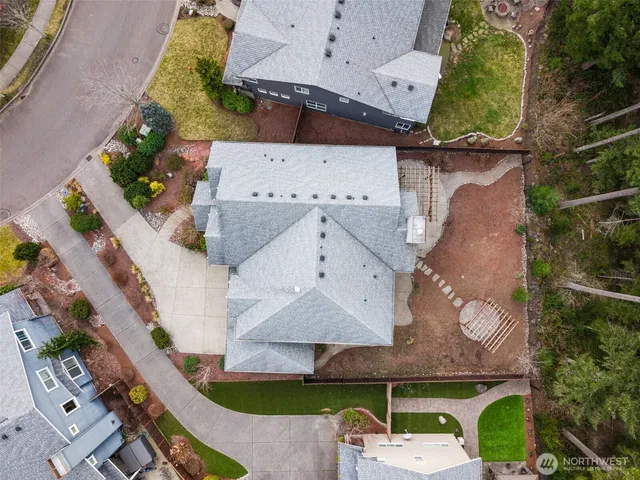 an aerial view of a house with garden space and street view