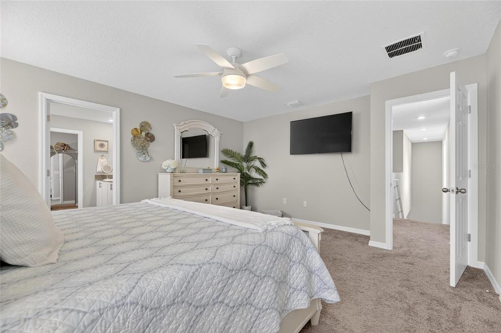 12908 Hawkstone Trail Boulevard Lithia, FL 33547 - Photo 23 of 76 a bedroom with a bed and a flat screen tv