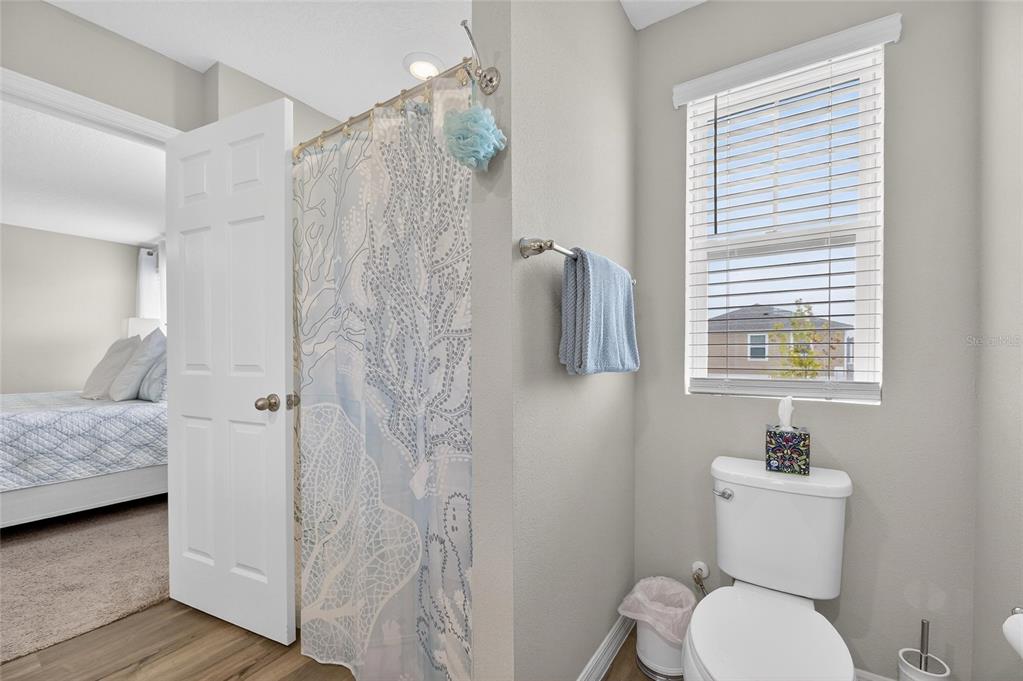 12908 Hawkstone Trail Boulevard Lithia, FL 33547 - Photo 26 of 76 a bathroom with a granite countertop sink toilet and shower
