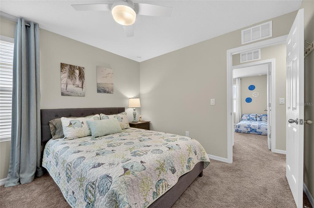 12908 Hawkstone Trail Boulevard Lithia, FL 33547 - Photo 31 of 76 a bedroom with a bed and a lamp