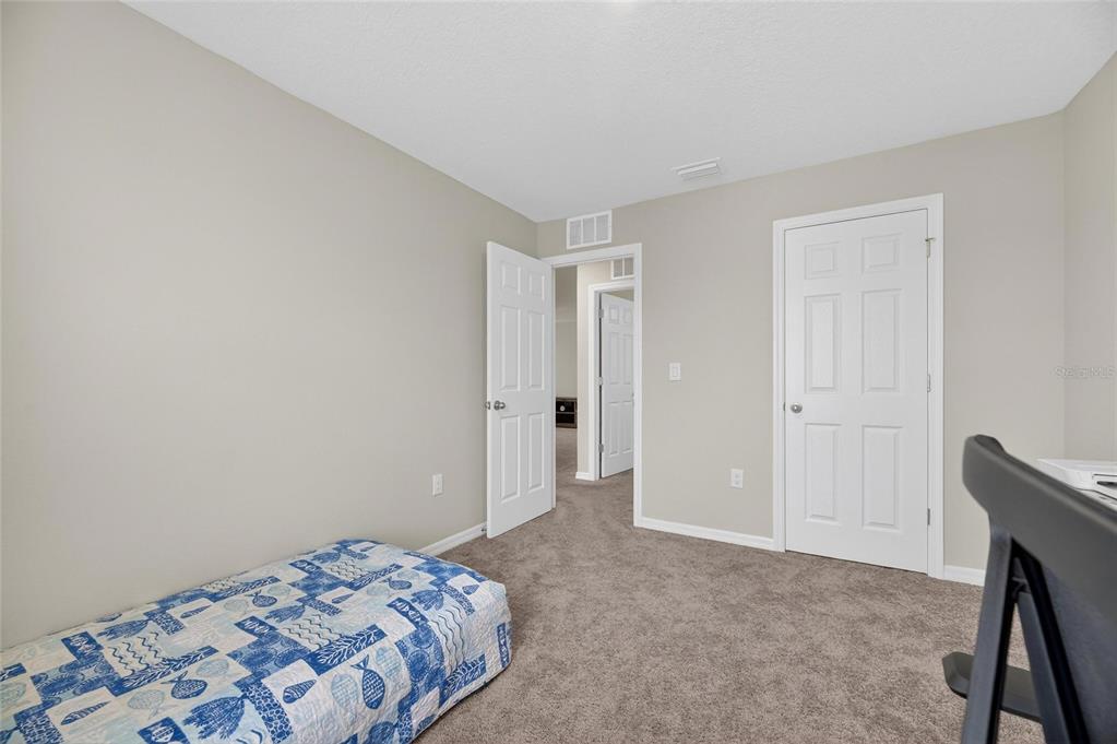 12908 Hawkstone Trail Boulevard Lithia, FL 33547 - Photo 34 of 76 a bedroom with a bed and a closet