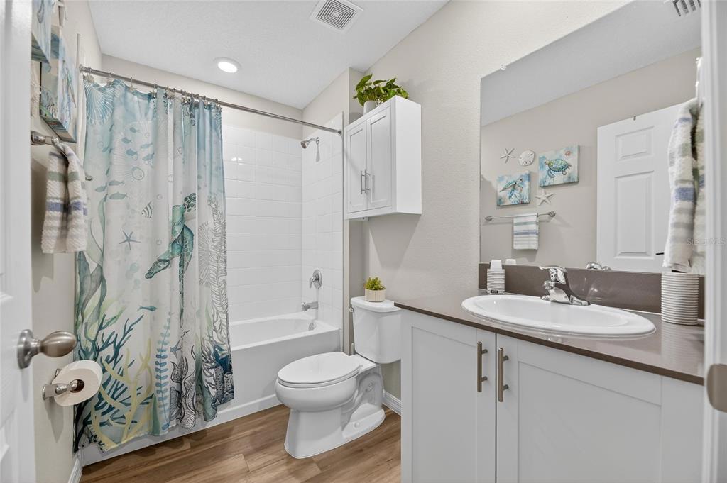 12908 Hawkstone Trail Boulevard Lithia, FL 33547 - Photo 36 of 76 a bathroom with a granite countertop sink toilet and shower