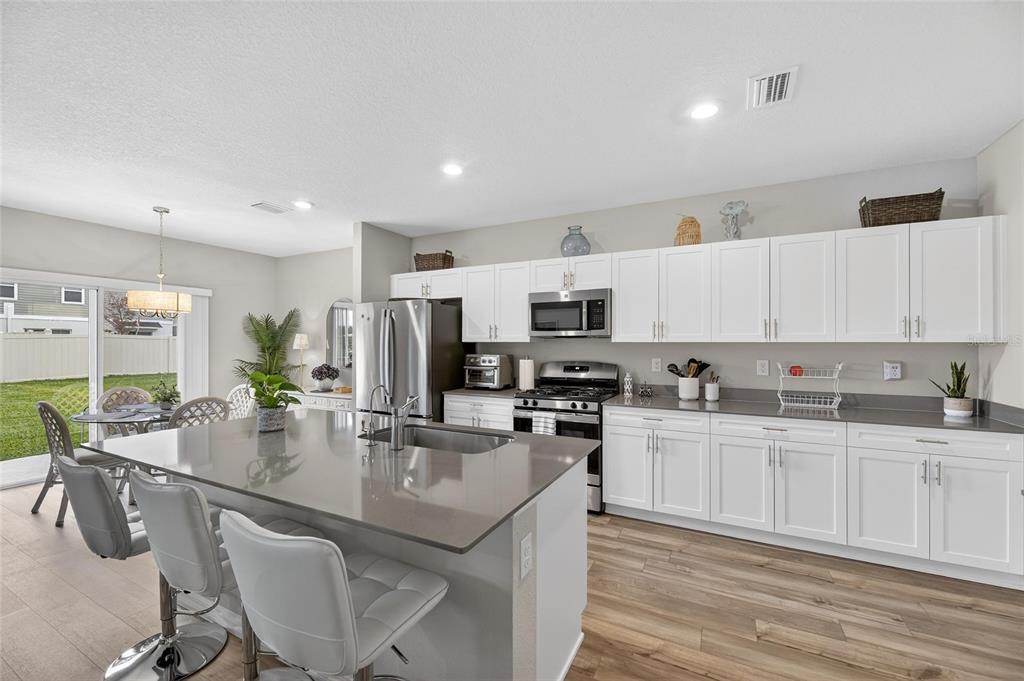 12908 Hawkstone Trail Boulevard Lithia, FL 33547 - Photo 5 of 76 a kitchen with stainless steel appliances granite countertop a sink and cabinets