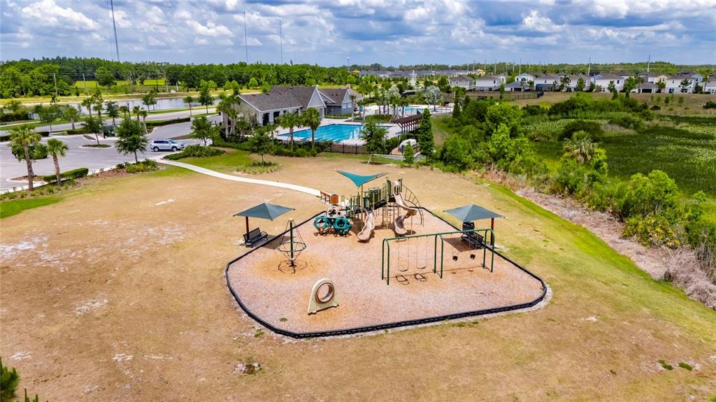 12908 Hawkstone Trail Boulevard Lithia, FL 33547 - Photo 62 of 76 a view of a swimming pool with a garden