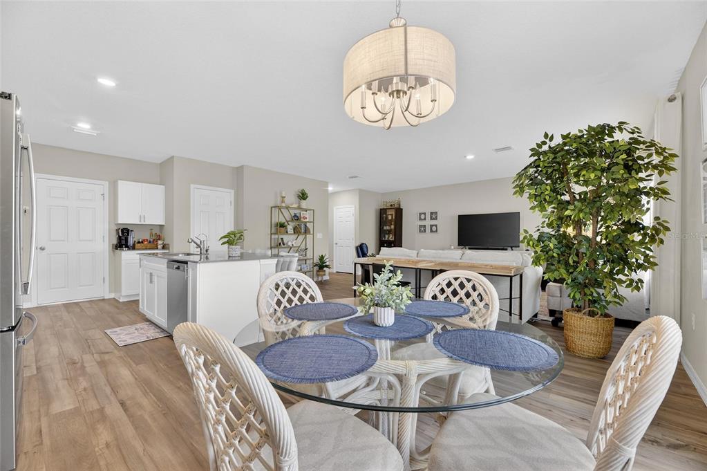 12908 Hawkstone Trail Boulevard Lithia, FL 33547 - Photo 7 of 76 a living room with furniture and a chandelier