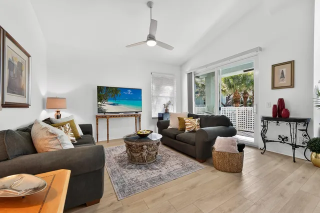 a living room with furniture a rug and a large window