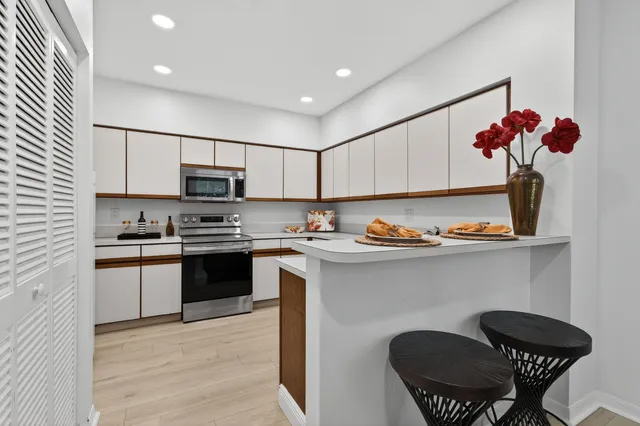 a kitchen with a sink cabinets and appliances