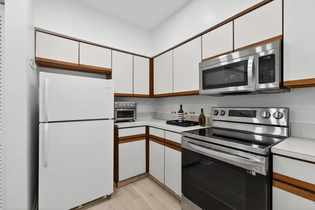 a bed room with a bed and a chair