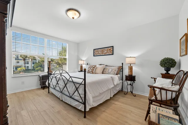 a bathroom with a toilet sink double vanity and mirror