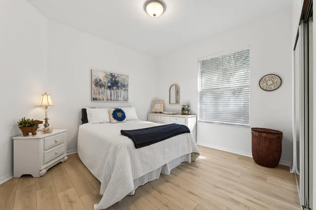 a bedroom with a bed and a painting on the wall