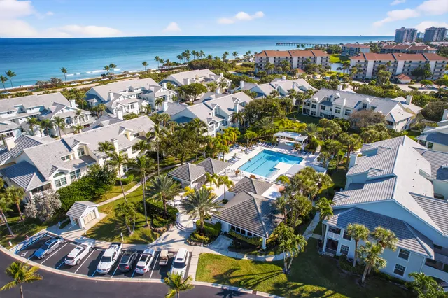 a view of a swimming pool with a lawn chairs and potted plants