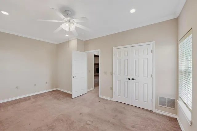 an empty room with fan and a ceiling fan