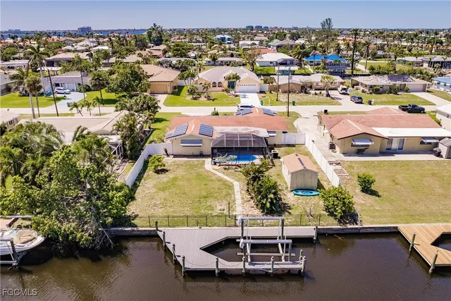 an aerial view of a house with a swimming pool outdoor seating and yard
