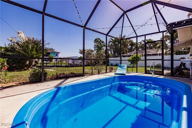 a view of a patio with a table and chairs under an umbrella