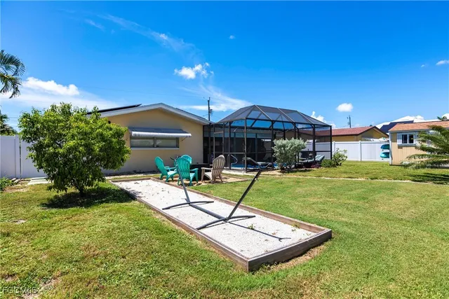 a view of a house with backyard sitting area and swimming pool