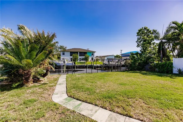 a swimming pool with outdoor seating and yard