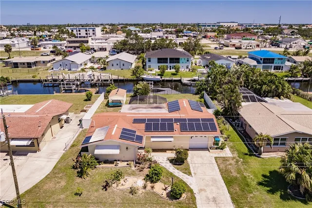 an aerial view of a house with a swimming pool yard and lake view