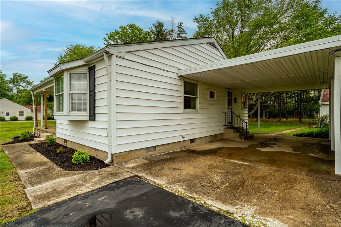 11296 Pansing Road Brookville, OH 45309 - Photo 36 of 53 This charming home offers a convenient carport and lush landscaping, providing both comfort and curb appeal.