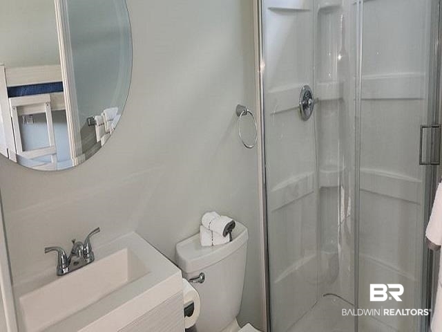 820 Carrozza Lane Foley, AL 36535 - Photo 20 of 45 Bathroom with vanity, toilet, and an enclosed shower
