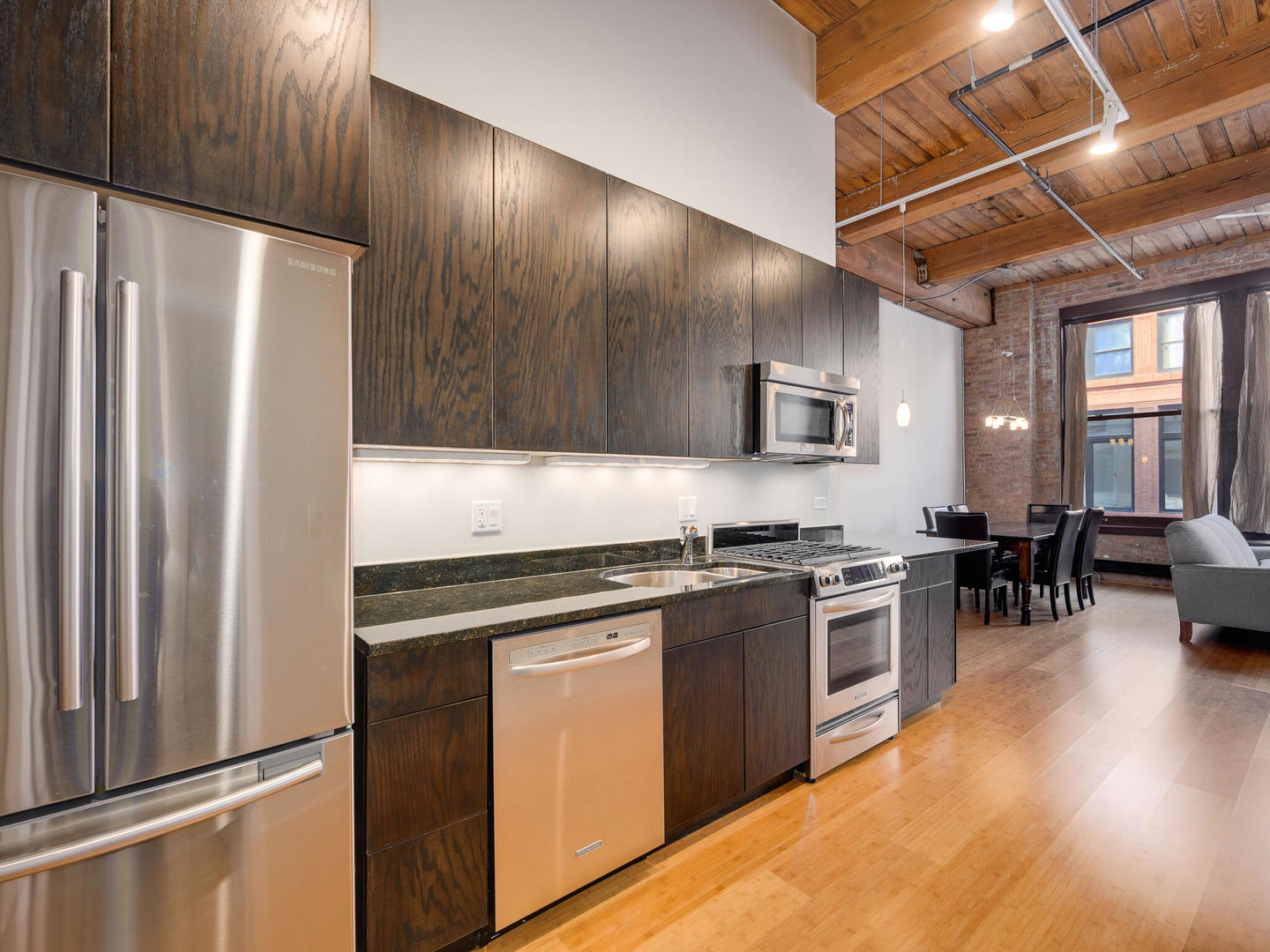 2303 South Michigan Avenue, Unit 305 Chicago, IL 60616 - Photo 13 of 22 a kitchen with stainless steel appliances granite countertop a stove refrigerator and chairs