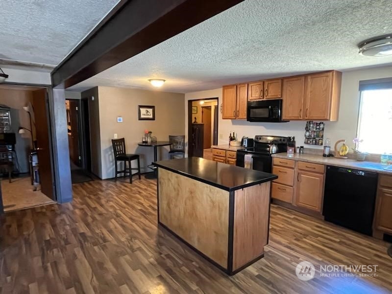592 North Military Road Winlock, WA 98596 - Photo 8 of 21 a kitchen with stainless steel appliances granite countertop a stove and cabinets