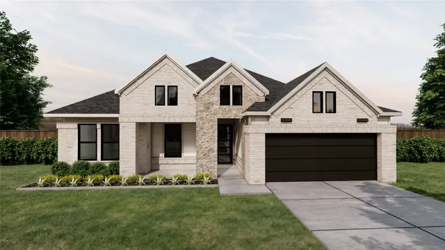 a front view of a house with a garden and yard