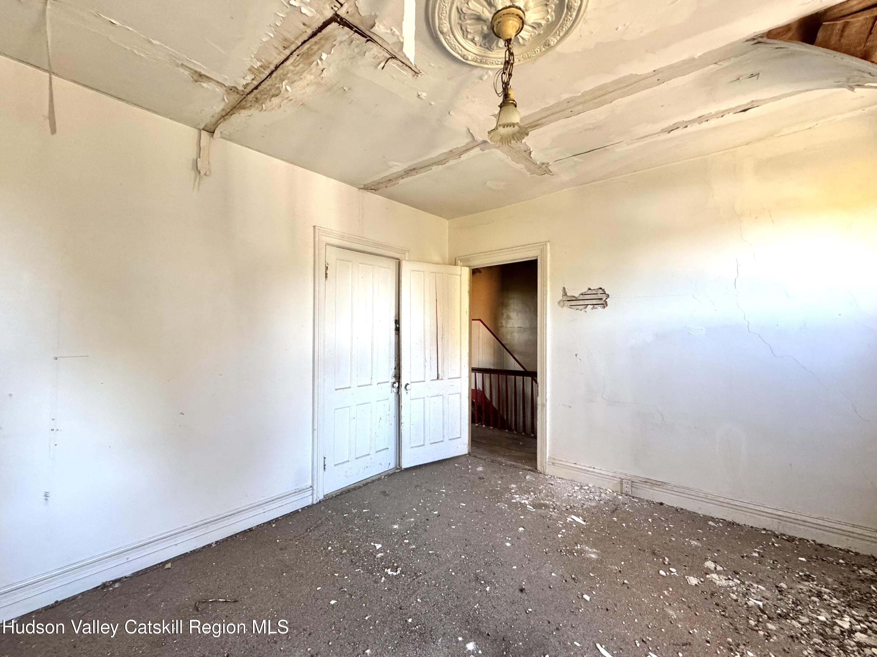 8 Howell Street Catskill, NY 12414 - Photo 11 of 14 a view of a room with a flat screen tv and refrigerator